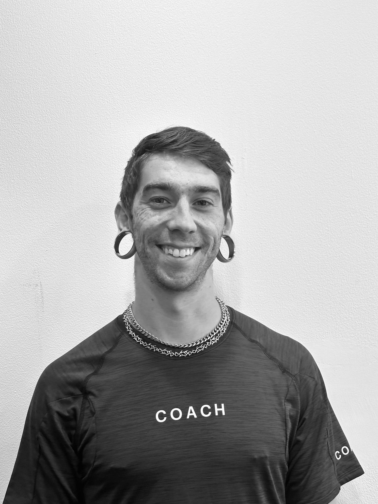 Black-and-white portrait of Coach Zach